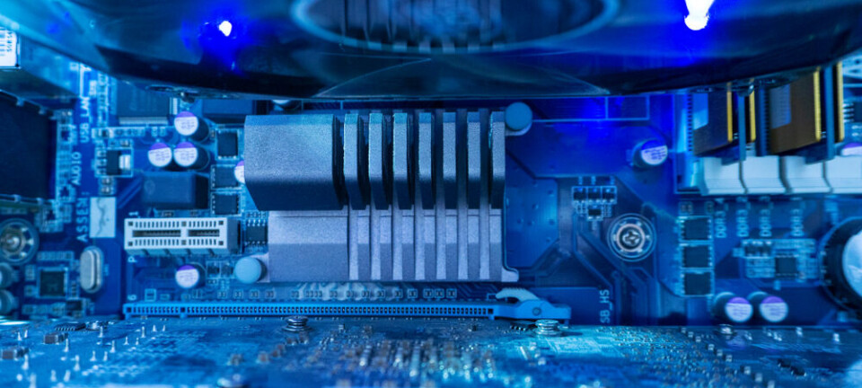 Inside a high performance computer. Computer circuit board and CPU cooling fans illuminated by internal LEDs inside a server class computer.