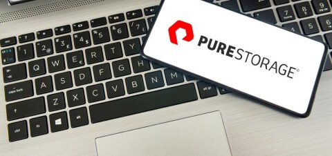 Pure Storage logo on smartphone, laying on a laptop