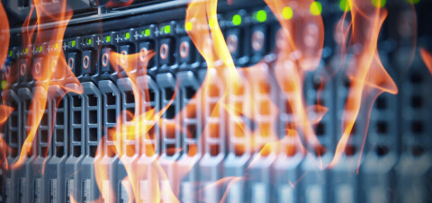 Flames spreading across the front of a data center server rack