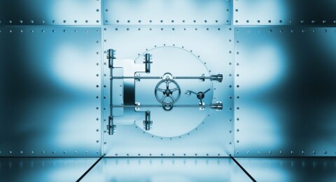 A blue-toned metal vault door with a circular locking mechanism set in a riveted steel wall